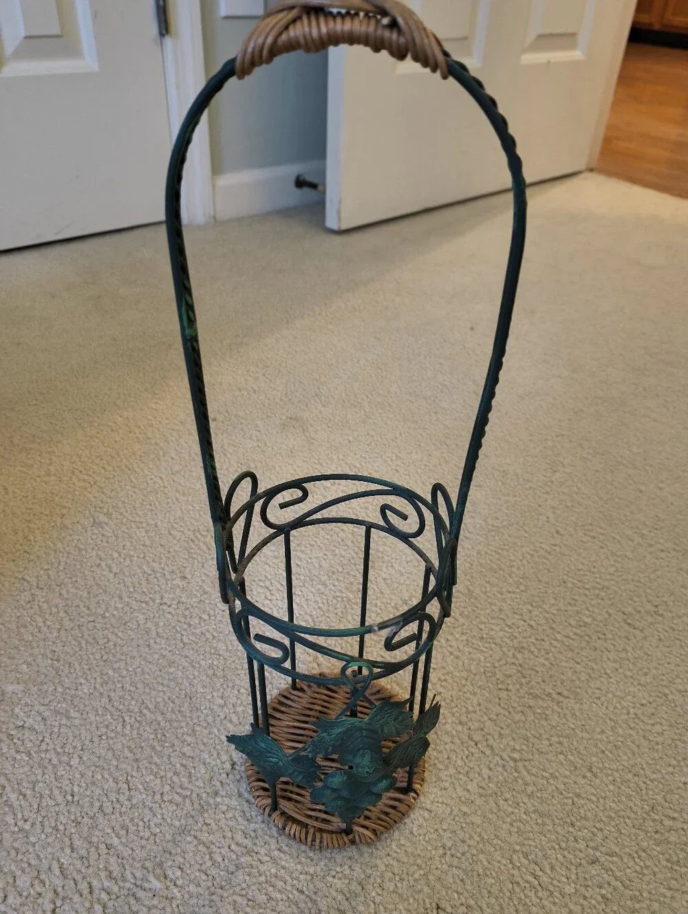 Green Metal Wine bottle Holder with Wicker Base and Leaves.